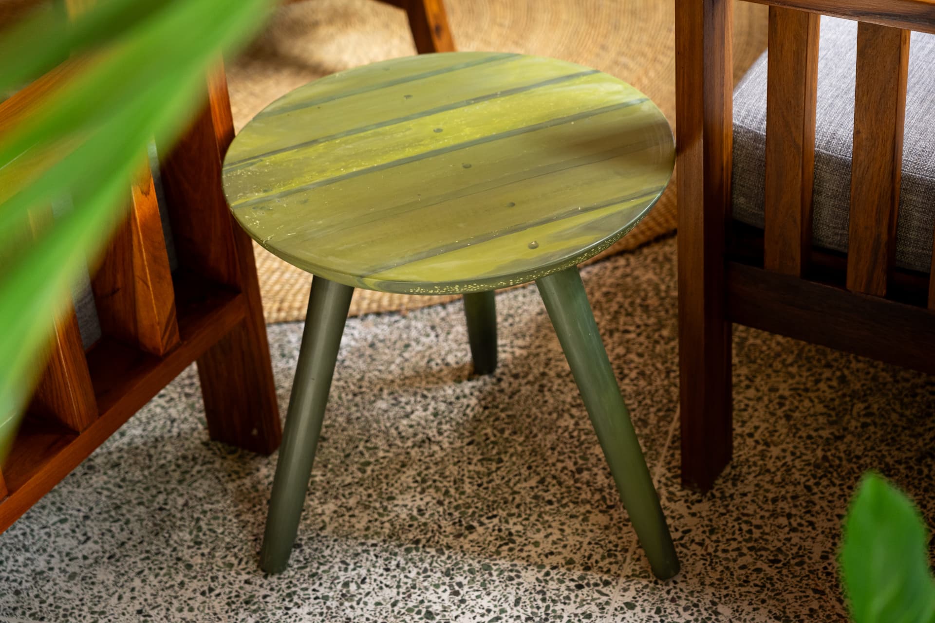 Olive marbled recycled plastic side table in a hardwood lounge setting